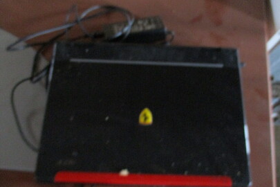 Ноутбук чорного кольору із червоною вставкою, марки ACER, с/н LXFR4051636460D60C2500, б/к робочий стан не перевірявся, кабель живлення відсутній