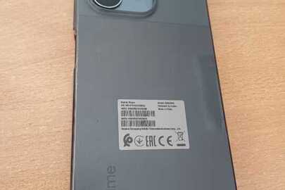 Конфіскований мобільний телефон марки «Realme» сірого кольору, модель: RMX3834, S/N: ON14704/241006A2, заблокований (пароль відсутній), б/в